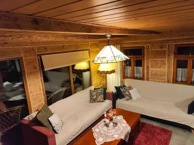 a living room with two white couches and a table at Sielanka, wyjątkowy dom, jacuzzi in Ślemień