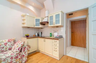 a kitchen with white cabinets and a couch at Kraków Centrum Free Parking 5 min do Rynku in Kraków