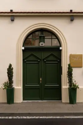 a green door on the side of a building at Soho Residence Kraków by Downtown Apartments in Kraków