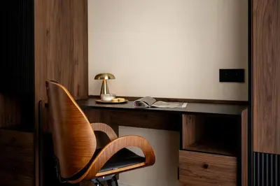 a wooden desk with a chair in a room at Soho Residence Kraków by Downtown Apartments in Kraków