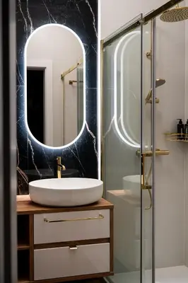 a bathroom with a sink and a mirror at Soho Residence Kraków by Downtown Apartments in Kraków