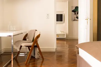 a dining room with a table and a table and chairs at Main Square Prestige Suites by Staymoovers in Kraków