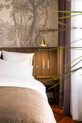 a bedroom with a bed and a wall mural at Main Square Prestige Suites by Staymoovers in Kraków