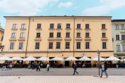 a large building with people walking in front of it at Main Square Prestige Suites by Staymoovers in Kraków