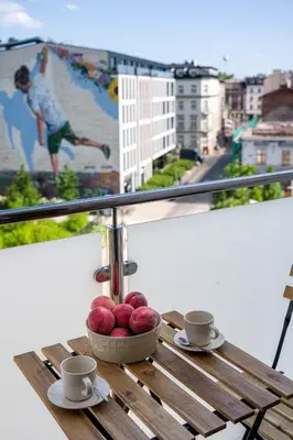a table with a bowl of fruit on a balcony at Spacious cental treasure in Kraków