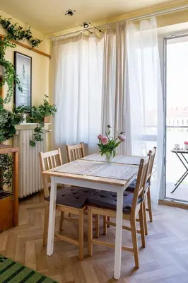 a dining room with a white table and chairs at Spacious cental treasure in Kraków