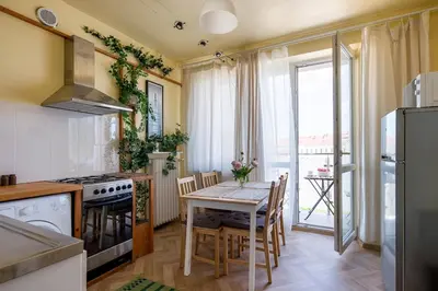 a kitchen with a table and a kitchen with a view at Spacious cental treasure in Kraków