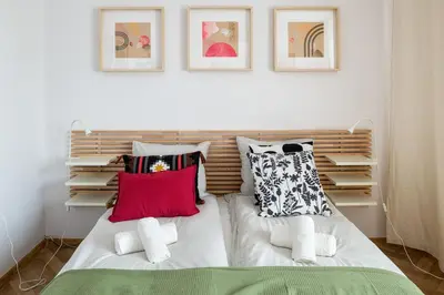 a bedroom with a bed with pillows on it at Spacious cental treasure in Kraków