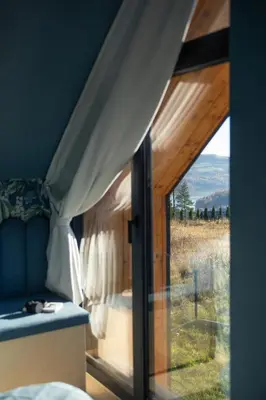 a bedroom with a window with a view of a field at Brzozowy Rożnów in Rożnów