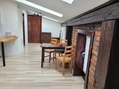 a dining room with a table and a brick fireplace at Golden Middle Point - best location in Krakow in Kraków