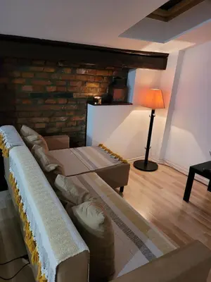 a living room with a couch and a lamp at Golden Middle Point - best location in Krakow in Kraków