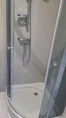a shower with a glass door in a bathroom at Golden Middle Point - best location in Krakow in Kraków