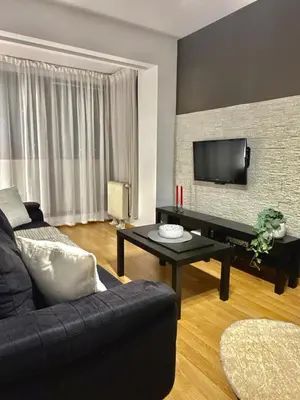 a living room with a couch and a tv at Modern Apartament in Kraków's Urban District in Kraków
