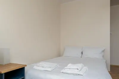 a white bed with towels on top of it at Czepca Quiet Corner Studio by BookingHost in Kraków