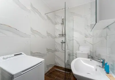 a white bathroom with a toilet and a sink at Czepca Quiet Corner Studio by BookingHost in Kraków