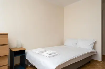 a bedroom with a bed with white sheets and a table at Czepca Quiet Corner Studio by BookingHost in Kraków