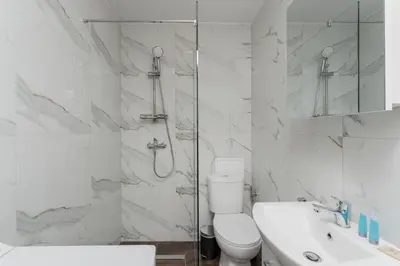a bathroom with a shower and a toilet and a sink at Czepca Quiet Corner Studio by BookingHost in Kraków