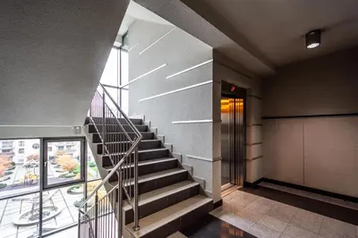 a spiral staircase in a building with a window at ShortStayPoland Grzegórzecka C6 in Kraków