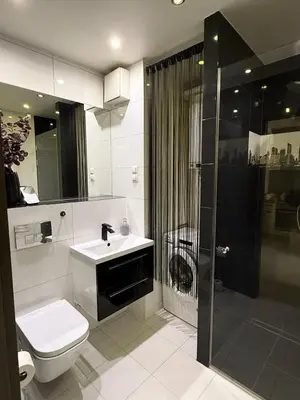a bathroom with a toilet and a sink and a shower at Cozy Kraków Escape - Wawel Castle - ICE Centre in Kraków