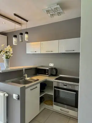 a kitchen with a sink and a microwave at Cozy Kraków Escape - Wawel Castle - ICE Centre in Kraków