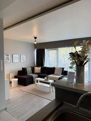 a living room with a couch and a table at Cozy Kraków Escape - Wawel Castle - ICE Centre in Kraków