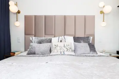 a bedroom with a large white bed with pillows at Riva Verona Apartment 86 in Kraków