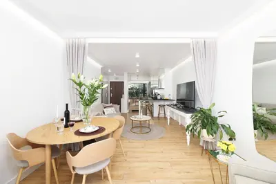 a kitchen and living room with a table and chairs at Riva Verona Apartment 86 in Kraków