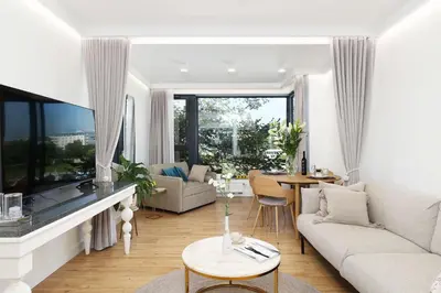a living room with a couch and a table at Riva Verona Apartment 86 in Kraków