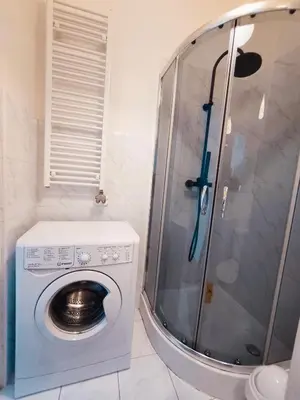 a washing machine in a bathroom with a shower at Krakow City Stay Home in Kraków