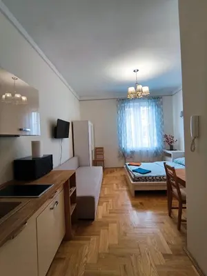 a room with a kitchen and a living room at Krakow City Stay Home in Kraków