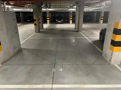 an empty parking garage with a car parked in it at Zakrzówek Apartament z Jacuzzi in Kraków