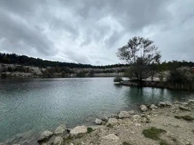 a large lake with rocks in the water at Zakrzówek Apartament z Jacuzzi in Kraków