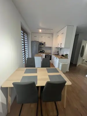 a kitchen and dining room with a table and chairs at Zakrzówek Apartament z Jacuzzi in Kraków