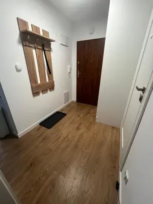 an empty room with a door and a wooden floor at Zakrzówek Apartament z Jacuzzi in Kraków