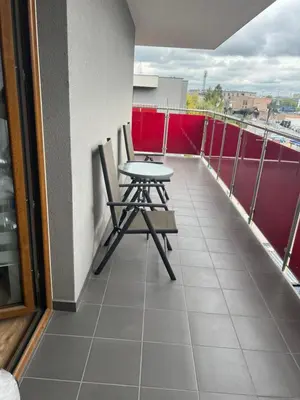 a table and two chairs on a balcony at Zakrzówek Apartament z Jacuzzi in Kraków
