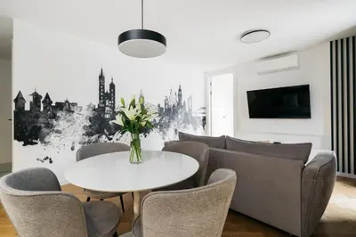a living room with a table and chairs at Native Apartments Kościuszki 39I14 in Kraków