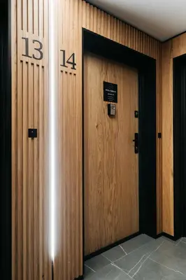 two wooden doors in a building with a sign on them at Native Apartments Kościuszki 39I14 in Kraków