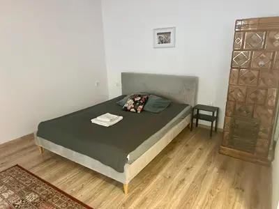 a bedroom with a bed and a chair in it at Wolnica Apartament 2 in Kraków