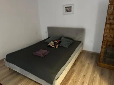 a bedroom with a large bed with a black comforter at Wolnica Apartament 2 in Kraków