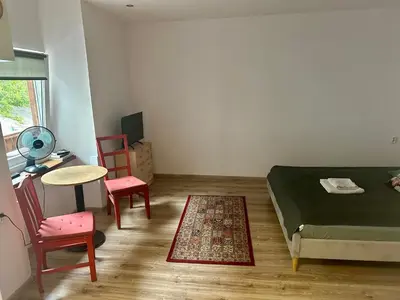 a bedroom with a bed and a table and chairs at Wolnica Apartament 2 in Kraków