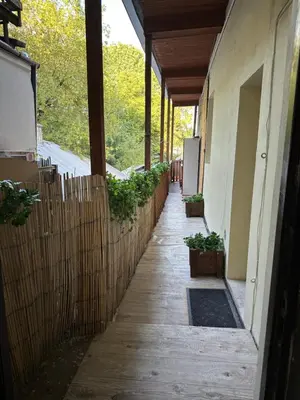 a hallway of a building with a fence and plants at Wolnica Apartament 2 in Kraków