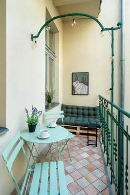 a balcony with a table and a couch at Discover Krakow Apartments - 8 Rakowicka St - Stylish Balcony Apartment with Netflix in Kraków
