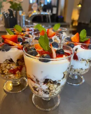 a row of desserts in glasses on a table at Discover Krakow Apartments - 8 Rakowicka St - Stylish Balcony Apartment with Netflix in Kraków