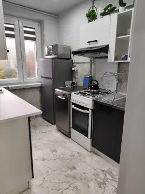 a kitchen with a stove and a refrigerator at Albertyńskie House in Kraków