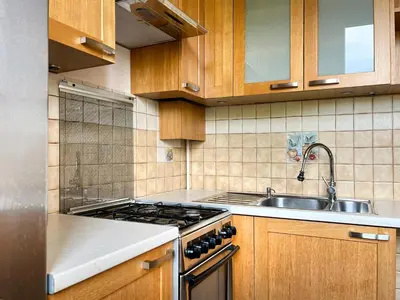 a kitchen with a stove and a sink at Cozy Two Bedrooms Apartment in Cracow City in Kraków