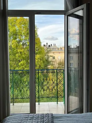 a bedroom with a view of a city from a window at Cozy Two Bedrooms Apartment in Cracow City in Kraków