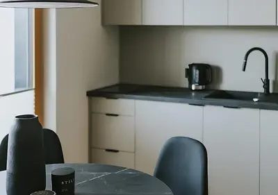 a kitchen with a table with chairs and a sink at Rakowicka Modern Apartment with Air Conditioning in City Center by Noclegi Renters in Kraków