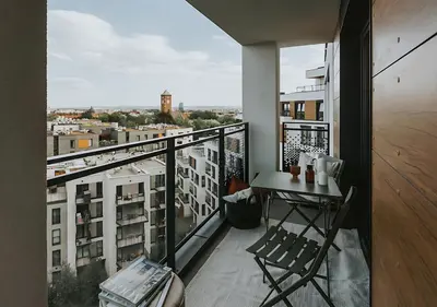 a balcony with a table and a view of a city at Rakowicka Modern Apartment with Air Conditioning in City Center by Noclegi Renters in Kraków