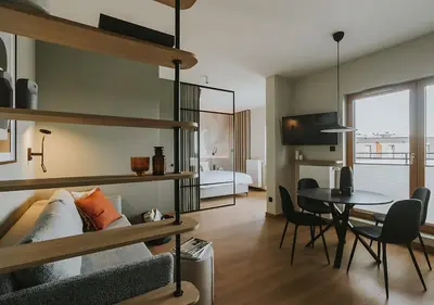 a living room with a loft bed and a table at Rakowicka Modern Apartment with Air Conditioning in City Center by Noclegi Renters in Kraków