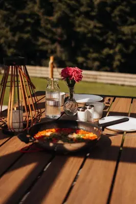 a room with a table with flowers on the floor at Honey House Wierchy- prywatna strefa SPA in Jaszczurowa